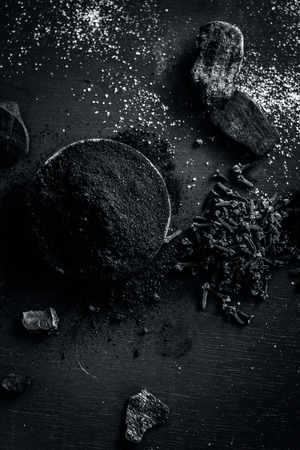 Traditional ingredients of toothpaste i.e. coal,clove,Syzygium aromaticum, and salt,sodium chloride on a wooden surface.の写真素材