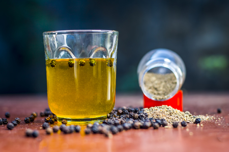 Close up of water of herb black pepper,kali mari or Piper nigrum on the wooden surface.の写真素材
