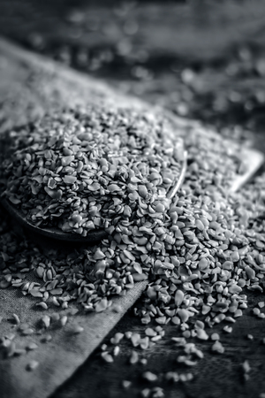 Crushed Fenugreek seeds,Trigonella foenum-graecum seeds,methi ke koriya in a bowl on wooden surface.の写真素材