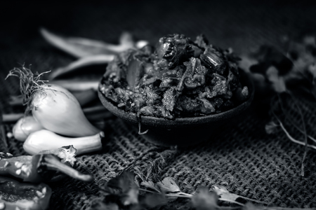 Close up of Indian Dish eaten in winter season Baingan ka Bharta with vegetables like:Spring onions,Allium fistulosum,Coriander,Coriandrum sativum,Garlic,Allium sativum and chills.の写真素材