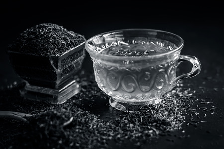 Black cumin seeds,shah jerra,Nigella sativa  and its tea on brown wooden surface.;の写真素材