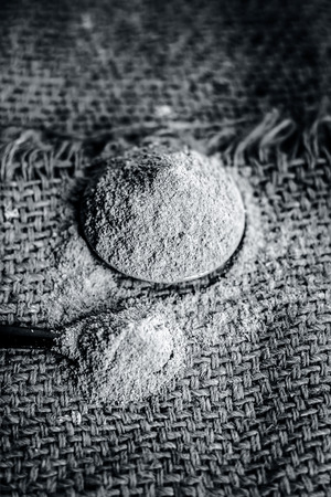 Close up of powder of babool fruit,Acacia nilotica Linn powder on gunny background is beneficial & ayurvedic medicine for tooth problems.の写真素材
