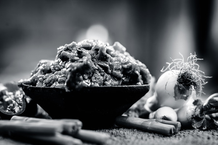 Close up of Indian Dish eaten in winter season Baingan ka Bharta with vegetables like:Spring onions,Allium fistulosum,Coriander,Coriandrum sativum,Garlic,Allium sativum and chills.の写真素材