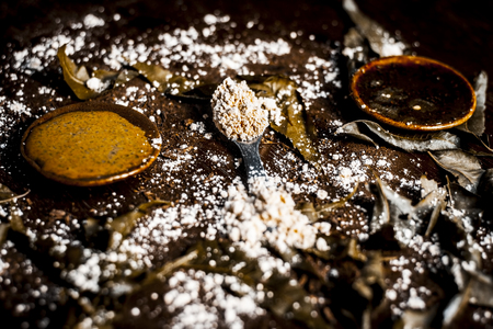 Azadirachta indica, Or Indian lilac Or NEEM TREEs leaves powder with gram flour and its face pack on a wooden surface for pimple less skin.の写真素材
