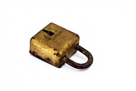 An golden lock isolated on a white surface.の写真素材