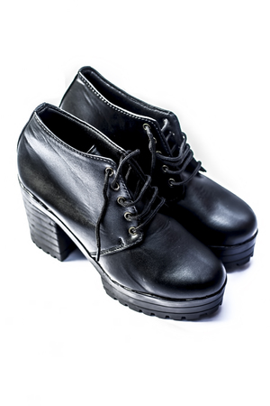 Close up of high heeled black womenâs shoes isolated on a white surface.の写真素材