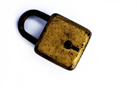 An golden lock isolated on a white surface.の写真素材