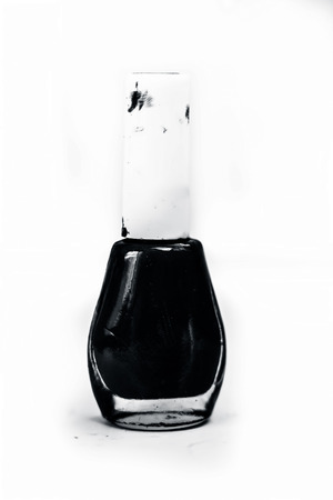 Purple and light ocean blue colored nail polish bottle isolated on a white surface.の写真素材