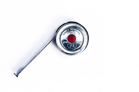 Measuring tape of labors for measuring the various objects isolated on a white.の写真素材