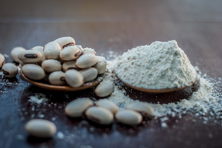 Ayurvedic herb kuanch,cowhage,Mucuna pruriens with powder in a brown plate with its powder and raw kuanch for premature ejaculation, erectile dysfunction and other sperm related diseases.の写真素材