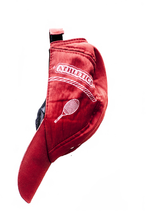 Red colored cap isolated on white.