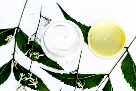 Close up of cream of Neem,Nim, Indian Iilac or Azadirachta indica with the leaves of neem tree isolated on white with benefits like it removes the black skin and acnes and pimples.の写真素材