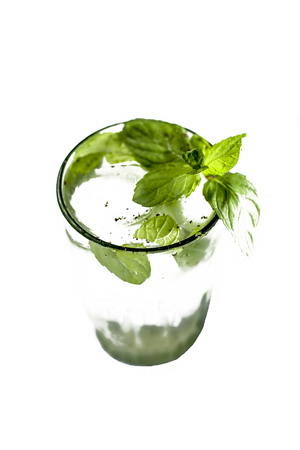 Fresh mint water with ice cubes on a white surface with fresh organic mint leaves.の写真素材