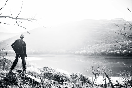 Close up of a young teenager standing deep in the wild forest at High Mountain wearing a cap.の写真素材