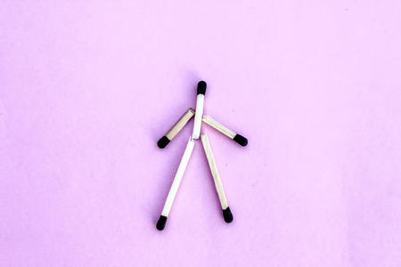 Crafting down with waste match sticks isolated on pink a men shape drawn.の写真素材