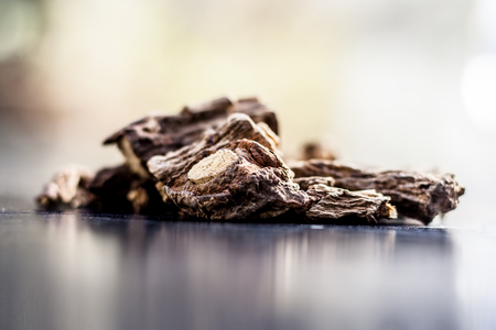 Ayurvedic herb or folk medicine Hemidesmus indicus or Nannari or Indian sarsaparilla dried roots on a wooden surfaceの写真素材