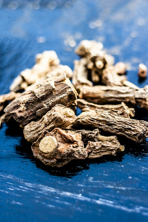 Ayurvedic herb or folk medicine Hemidesmus indicus or Nannari or Indian sarsaparilla dried roots on a wooden surfaceの写真素材