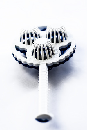Blue and white colored plastic rattle isolated on white.の写真素材