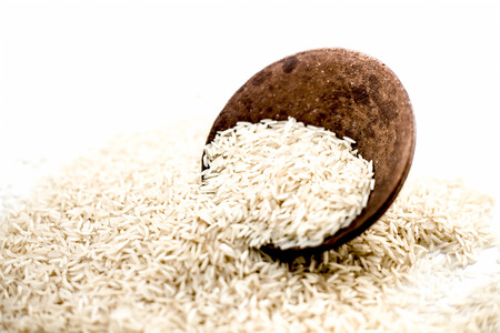 Indian special most popularuncooked Basmati long grained with a unique aroma in a clay bowl isolated on white.の写真素材
