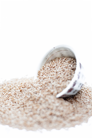 Sesame seeds or or white sesame seeds or tel or til or tal in a bowl isolated on white.の写真素材