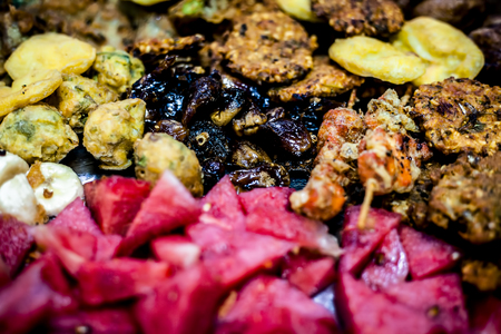 Snacks and fruits with black and common dates with drinks and Halwa grass or china grass time for Iftaar or iftar. Iftar plate.の写真素材