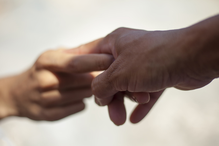 Helping Hands. A human hand helping other human hand to over come his fear about exam result or about future.の写真素材