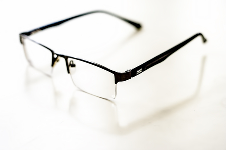 Black colored half frame rim reading glasses or spectacles to cure eye disease myopia.の写真素材