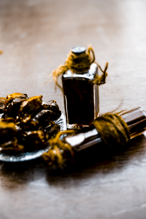 Sweet and floral essence of Date or khajoor in bottles on wooden surface used i flavored chocolate and in drinks and beverages.の写真素材