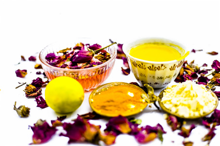 Close up of face pack of rose water and powder of turmeric and gram in a bowl isolated on white.の写真素材