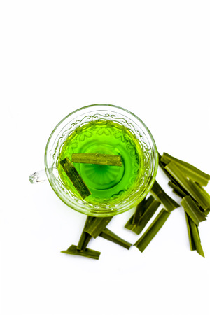 Green colored tea of lemon grass in a transparent cup isolated on white used in many ayurvedic treatments.の写真素材