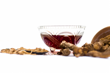 Dried Indian sarsaparilla or Hemidesmus indicus or nannari or annatmol with its syrup and powder used in mant Indian & Asian beverages isolated on white.の写真素材