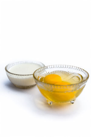 Ayurvedic calcium supplement ingredients isolated on white i.e. Raw eggs with milk.の写真素材