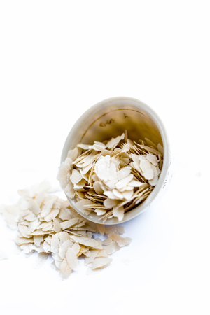 Close up of Flattened rice or beaten rice or Phoa or pava in a bowl isolated on white.の写真素材