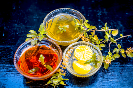 Close up of fresh leaves of holy basil with raw honey and lemon juice the home remedy to cure the diseases: For asthma attack and for cough its ingredients on wooden surface.;の写真素材