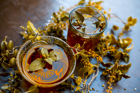 Effective ayurvedic home remedy for Fever and common cold: Basil leaves with warm water and honey.;の写真素材