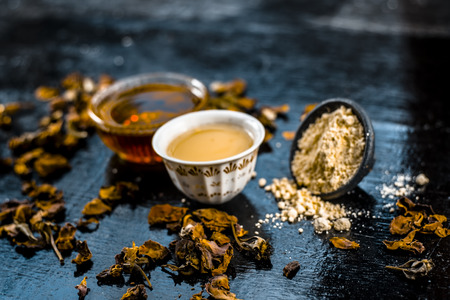 Close up of honey, gram floor and its  mixture in a clay bowl on wooden surface.の写真素材
