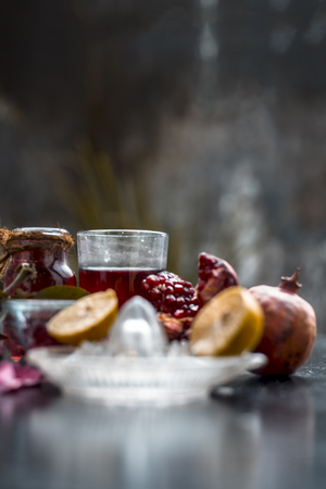 Close up of herbal face pack of pomegranate and lemon juice with rose water on wooden surface with...