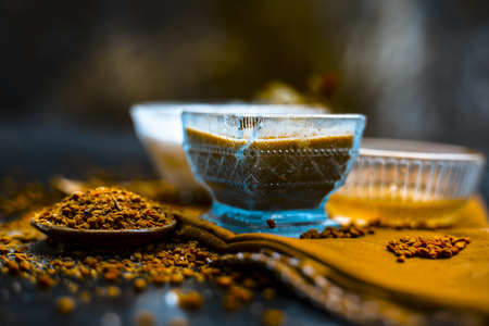 Herbal and organic home remedy for hair fall i.e. Egg white mixed with curd and fenugreek seeeds in a bowl,On wooden surface with raw fenugreek or methi seeds and curd with egg shells,Close up view.の写真素材