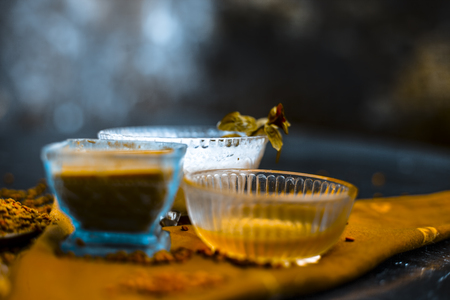Herbal and organic home remedy for hair fall i.e. Egg white mixed with curd and fenugreek seeeds in a bowl,On wooden surface with raw fenugreek or methi seeds and curd with egg shells,Close up view.の写真素材
