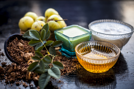Close up of herbal face pack of Indian gooseberry or amla with curd or yogurt and honey in a glass bowl on wooden surface used to have instant bright skin.の写真素材
