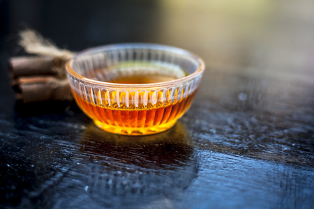 Ingredients of apple cider or apple cider vinegar i.e. raw apple or seb or malus, cinnamon stick and honey on wooden surface.Close up shot or top shot.の写真素材