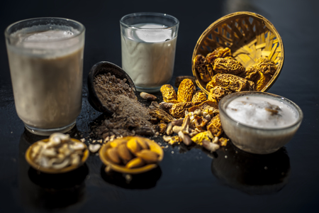 Close up of popular Indian and asian Winter drink on wooden surface i.e. Kharek ka dudh or dried...