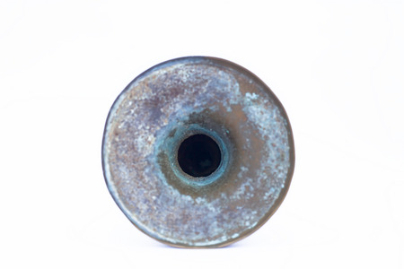 Close up of old ancient vessel or utensil or container or isolated on white i.e. Chilamchi or chelam or spit container or spittoon or brass spit container isolated on white.の写真素材