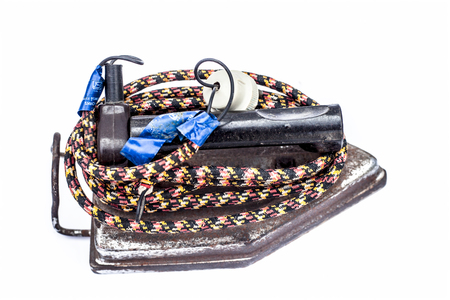 Junagadh-Gujarat-India-December 31st 2018- Close up of rusted steam iron isolated on white with its wire.のeditorial素材