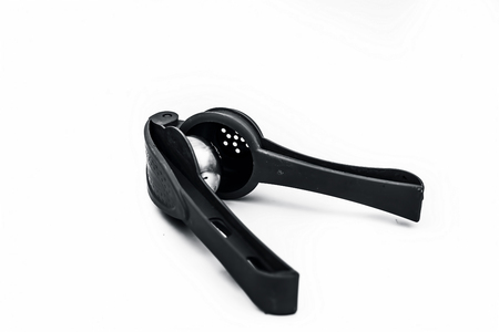 Close up of red colored hand squeezer isolated on white.の写真素材