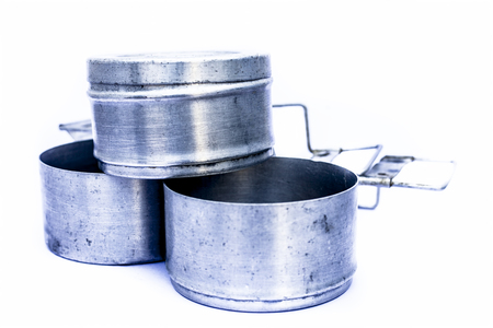 Close up of  aluminum tiffin box or lunch box isolated on white used by kids and employees to take their lunch or breakfast with them at office or school.の写真素材