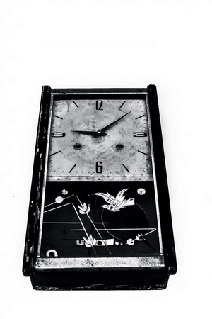 Close up of brown and yellow colored ancient wall clock or pendulum clock isolated on white.