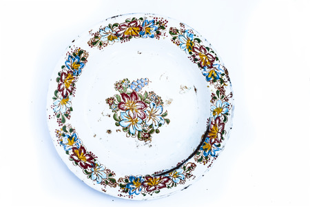 Close up of antique colorful glass plates isolated on white used for dinning everyday.の写真素材