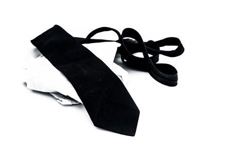 Close up of black colored tie and a white colored handkerchief isolated on white.の写真素材