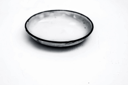 Close up of white colored dinning plate with a thin blue colored outline isolated on white.の写真素材
